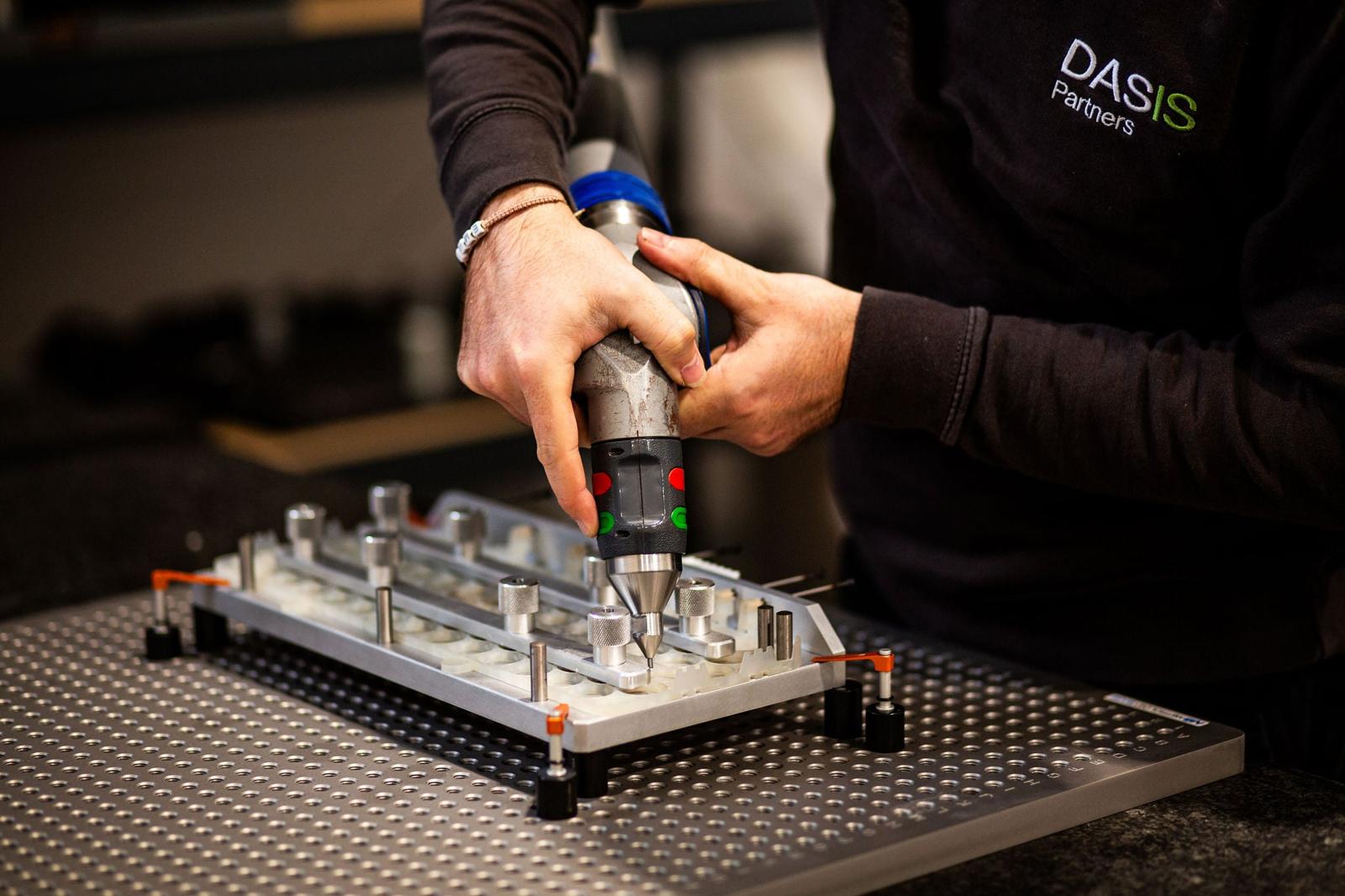 Technician using a power tool to assemble a component on a jig
