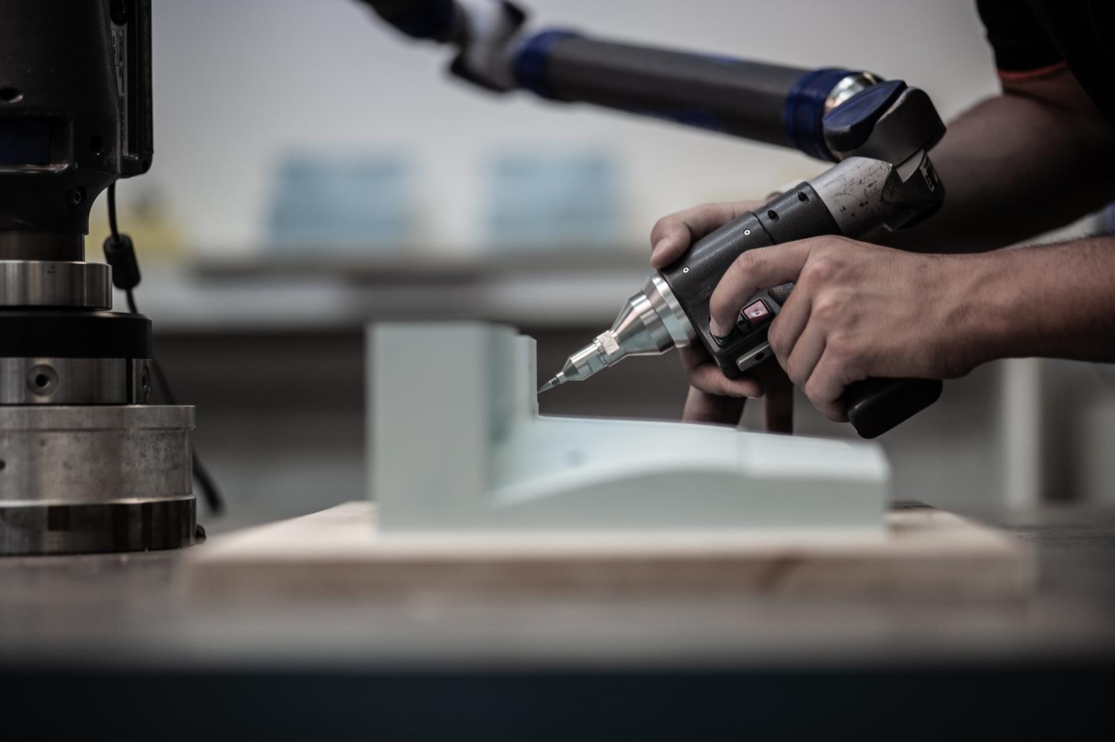 Coordinate measuring machine probe inspecting a machined component