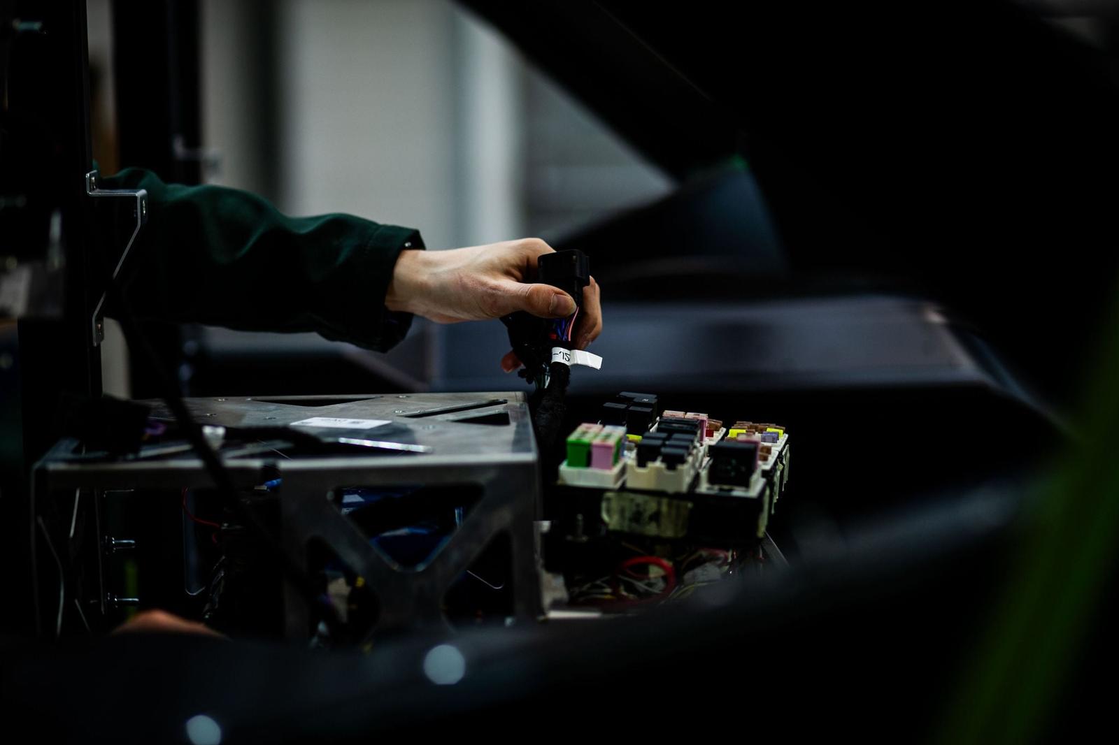 Engineer working on a machine in a dimly lit workshop