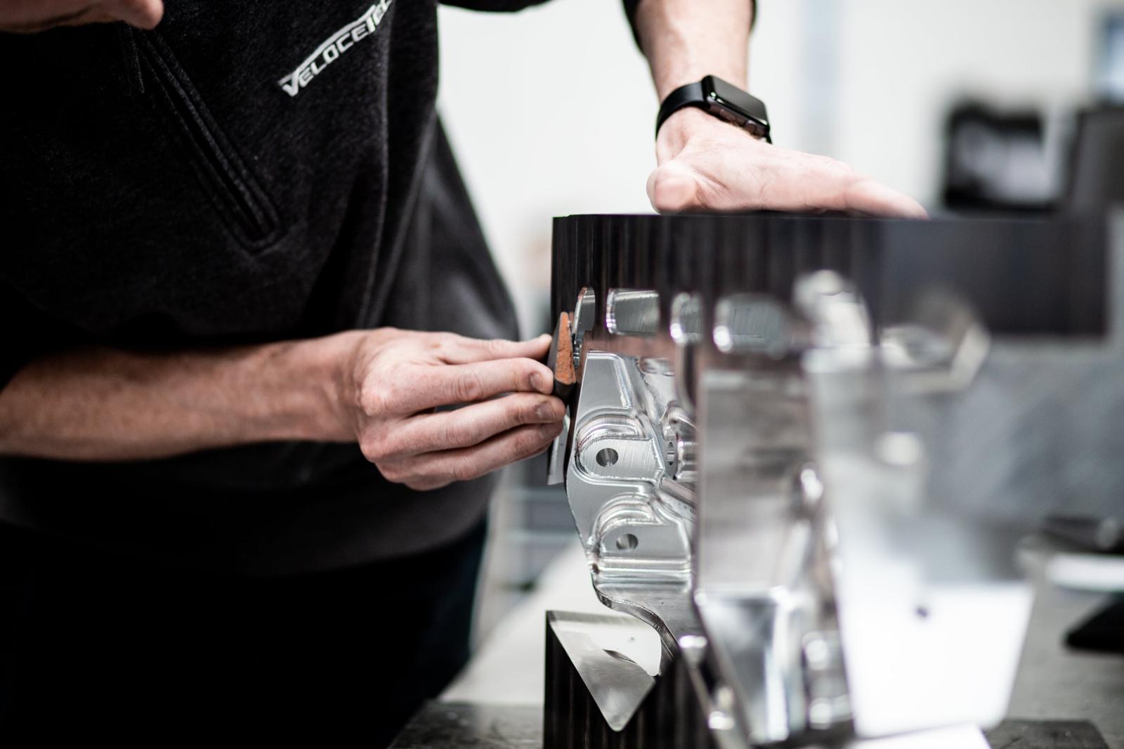 Technician holding a precision-machined part in the workshop