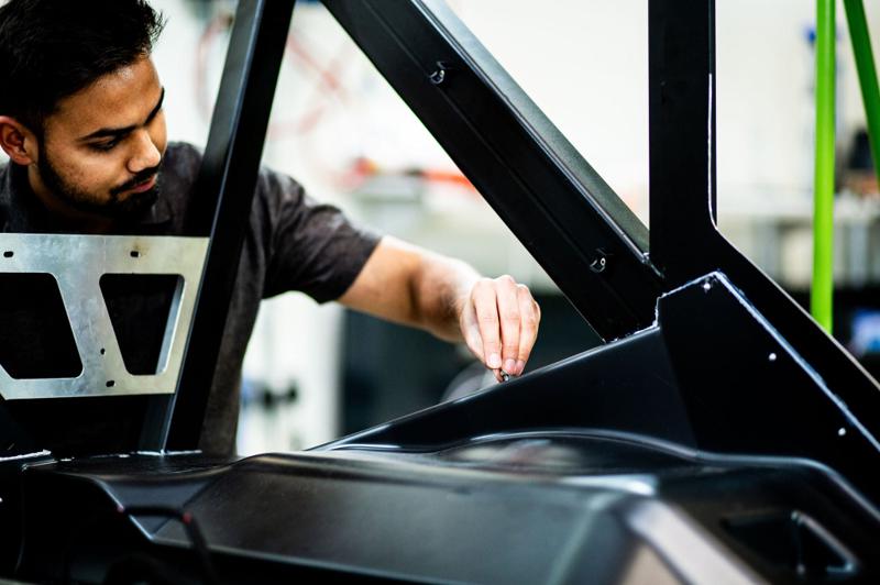 DASIS engineer working on a vehicle frame