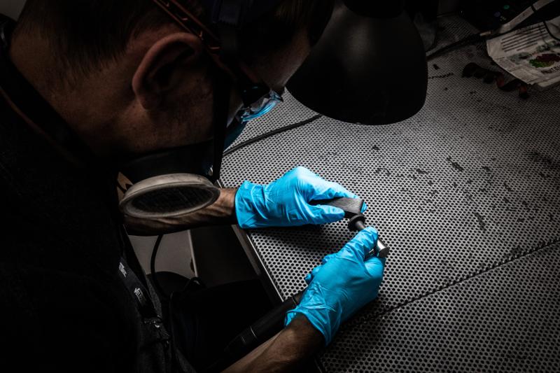 Velocetec technician in blue gloves carrying out a precision inspection