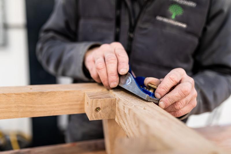 Hands hand-finishing timber at JCM Fine Joinery
