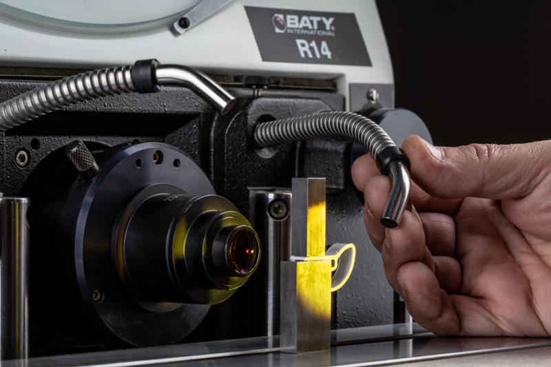 Shadowgraph measuring machine inspecting a machined part