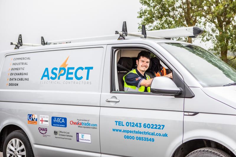 Aspect engineer in hi-vis driving a branded company van