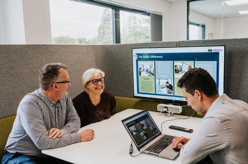 A client team watching a presentation on screen at a table