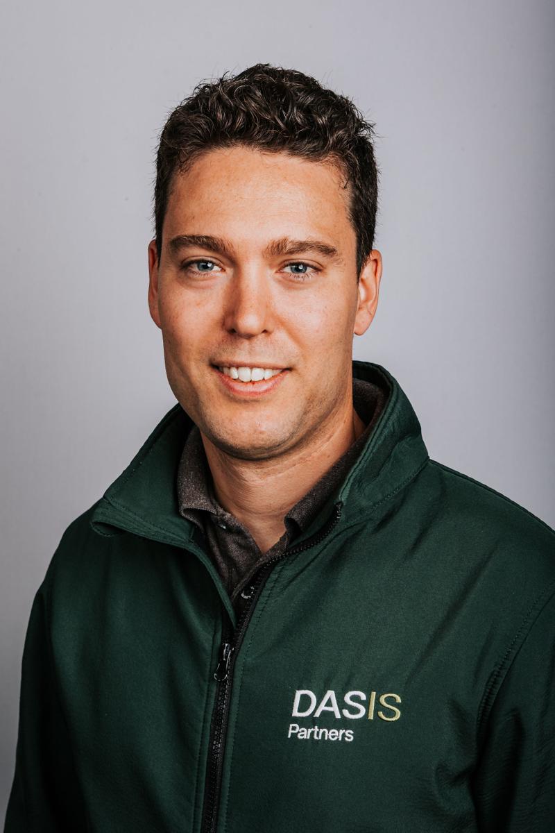 Headshot of a DASIS Partners team member in a green polo shirt