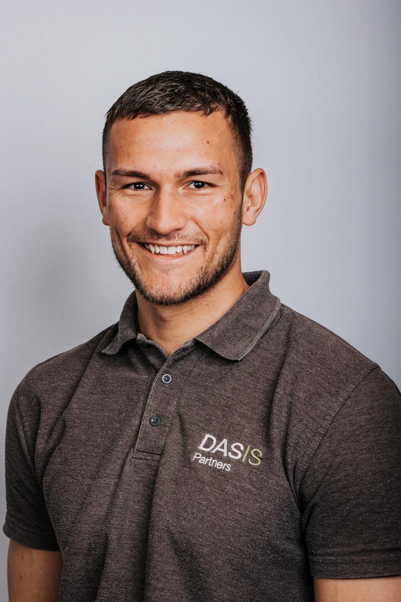 Headshot of a DASIS Partners team member in a grey polo shirt