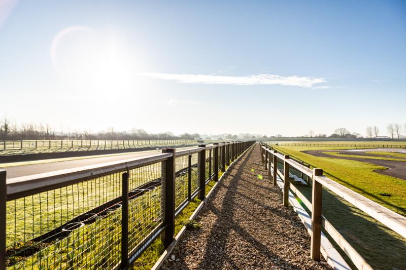 Knight Fencing post-and-rail fence in a sunlit field