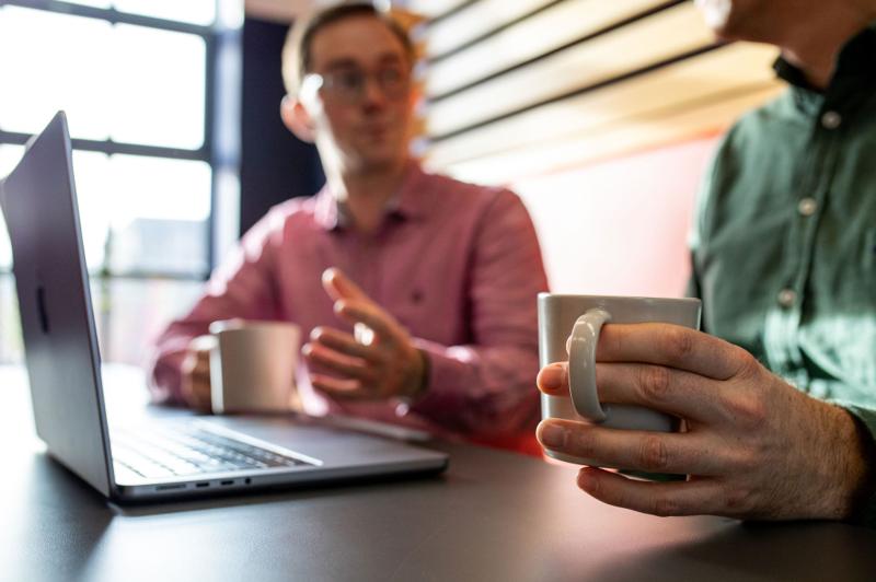 Pallant consultant in a meeting with coffee