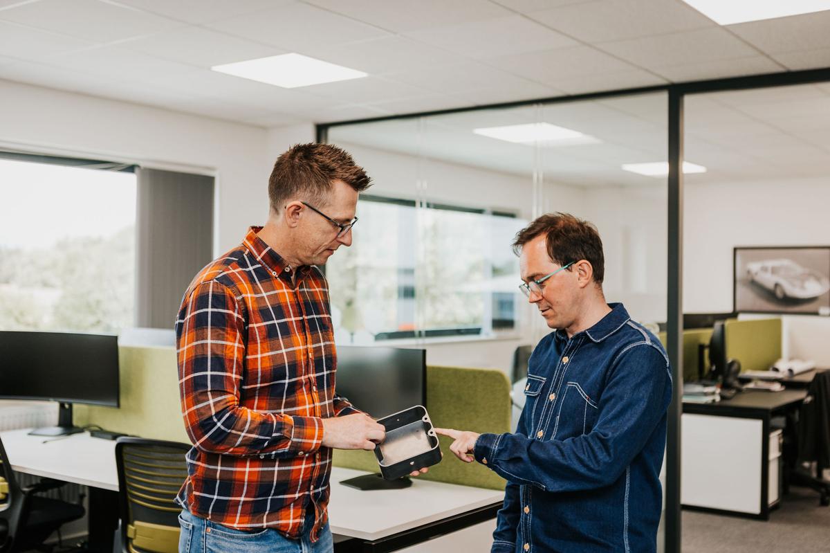 Two Pallant marketing consultants reviewing a campaign on a tablet in the studio office