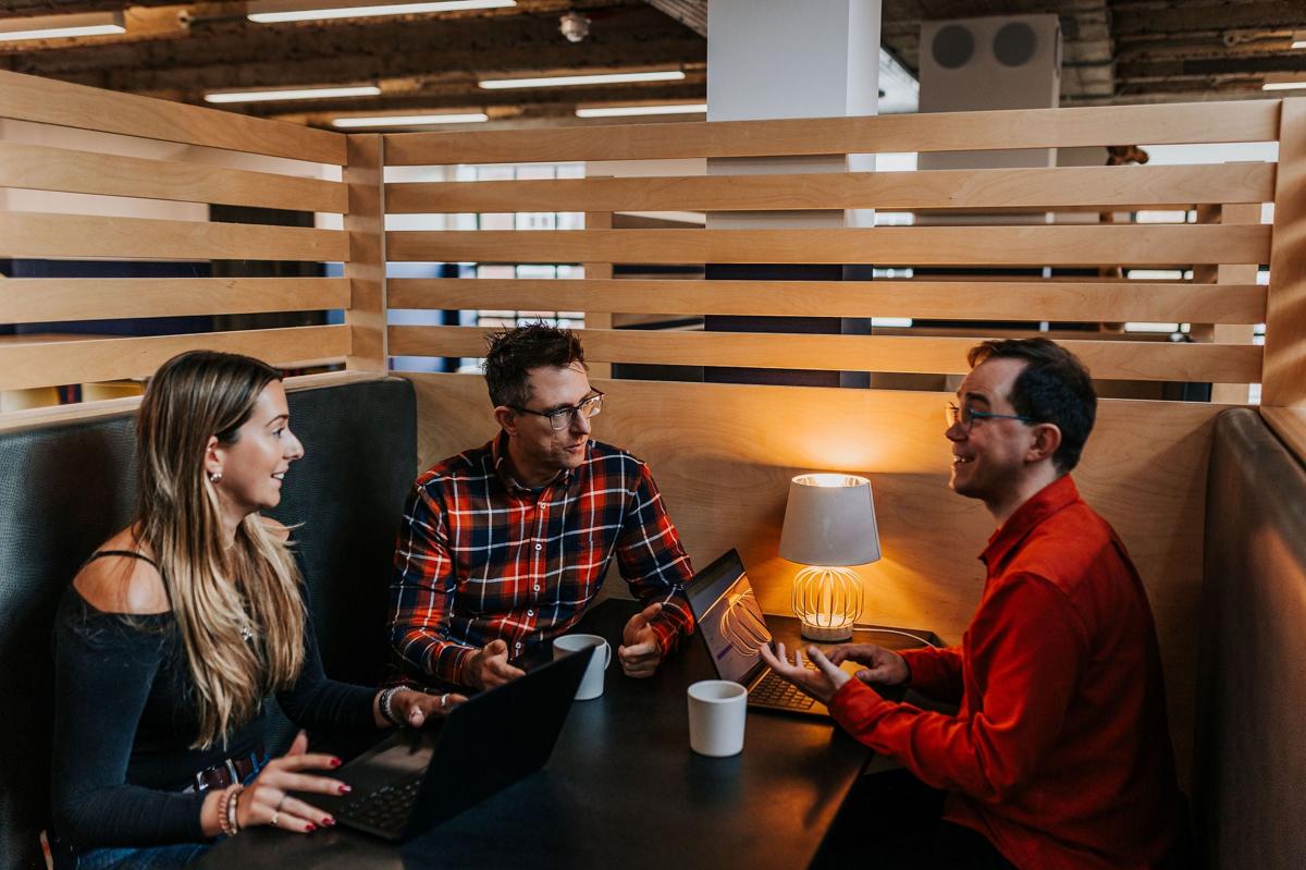 Pallant colleagues talking over coffee in a studio booth