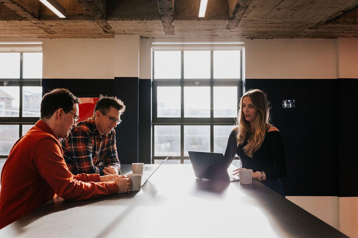 Pallant team working at a meeting table by the window