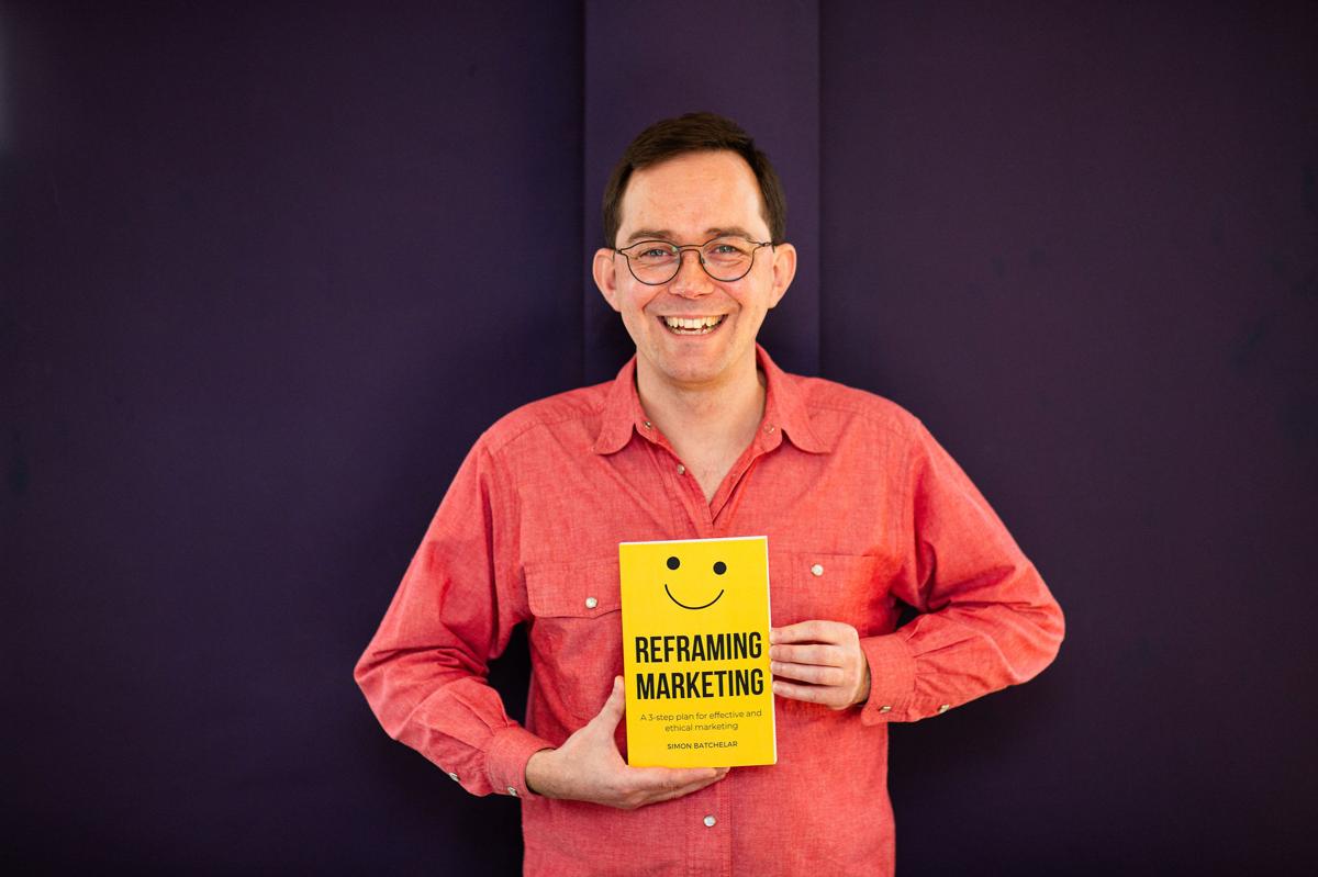 Simon Batchelar with his book, Reframing Marketing